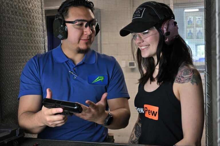 A Range 702 Instructor Teaching A Client About Gun Safety.